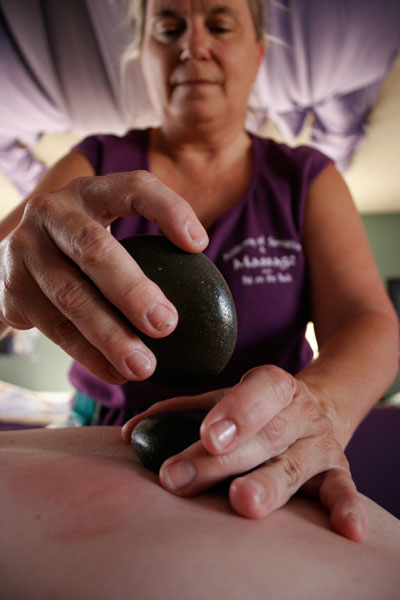 Hot stone massage treatment in progress